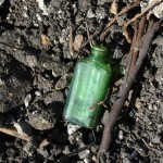 st mary cemetery green bottle in ploweed field